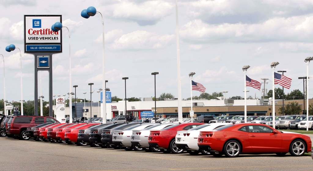 A line of cars at a used car dealership