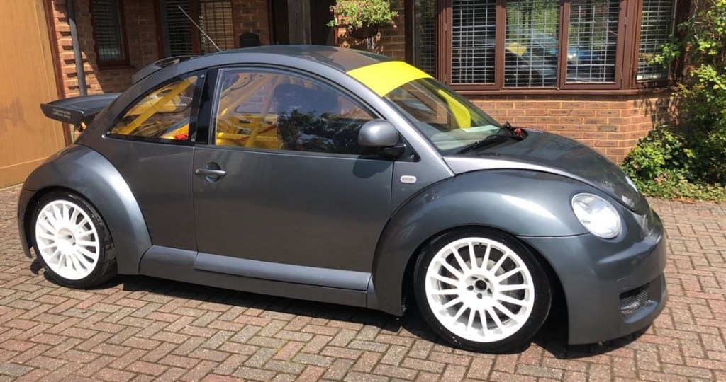 A gray Volkswagen Beetle RSI Cup Car with a yellow interior and roll cage