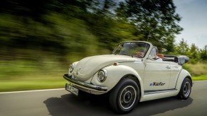 A white classic Volkswagen Beetle convertible converted to electric power