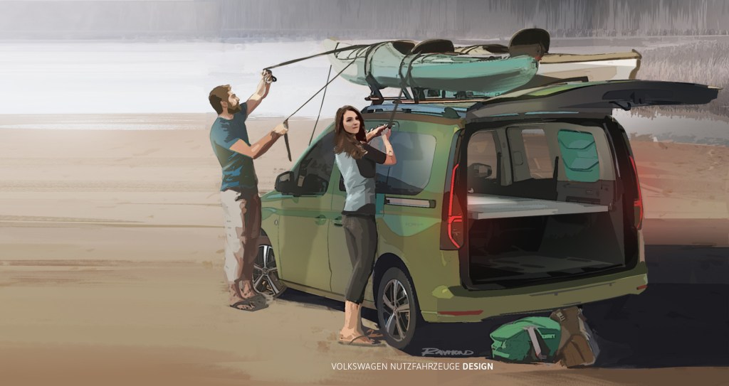 A young couple straps down a kayak to the top rack of a Volkswagen Caddy camper.