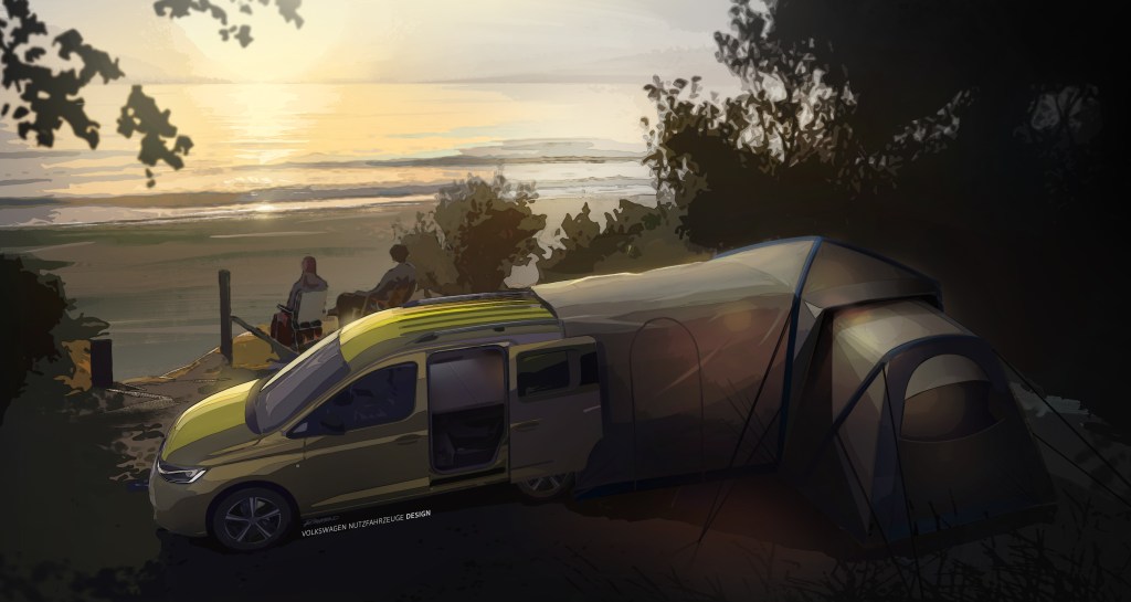 A green Volkswagen Caddy camper is set up on a hillside, with a tent attached to the back liftgate, at dusk.