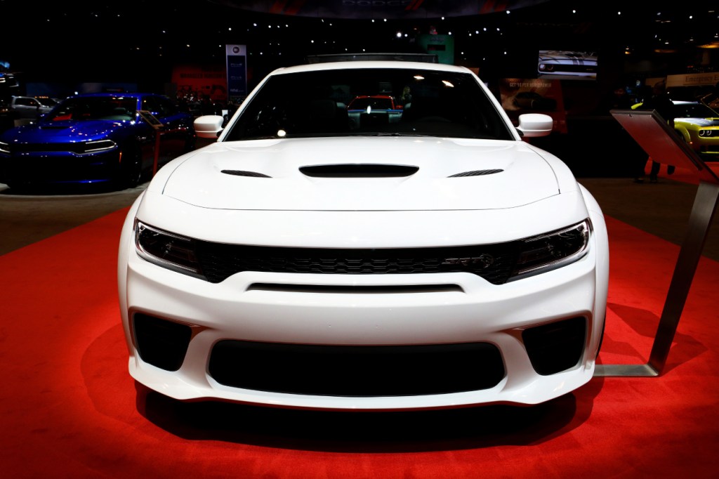 A white 2020 Dodge Charger on display at an auto show