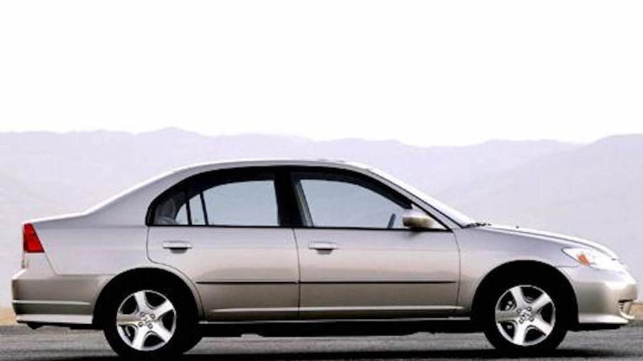 sideview of a beige Honda Civic 2004 model year with mountains in the background