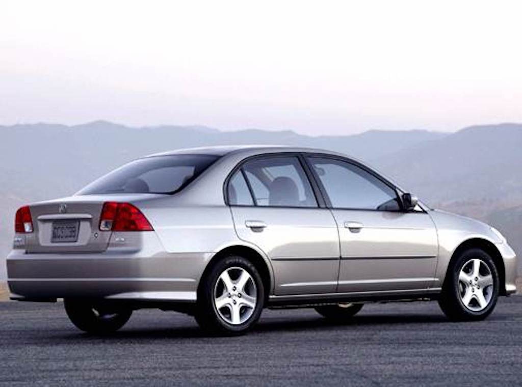side rear view of the 2004 Honda Civic sedan with a mountainous background