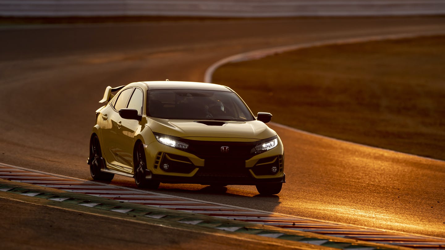 a yellow civic type r on the track at speed