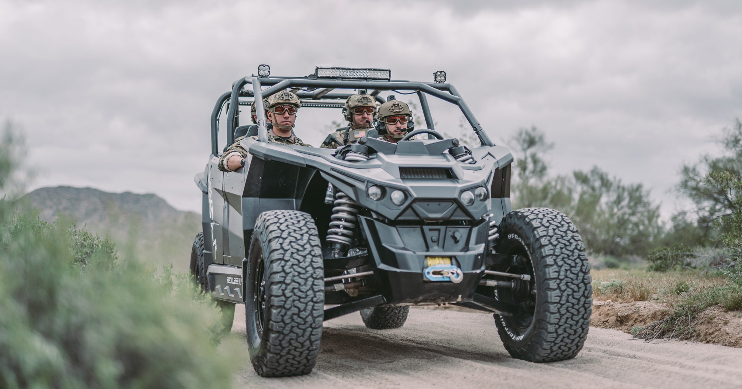 A Nikola Reckless is loaded up with soldiers and heading down a dirt road.