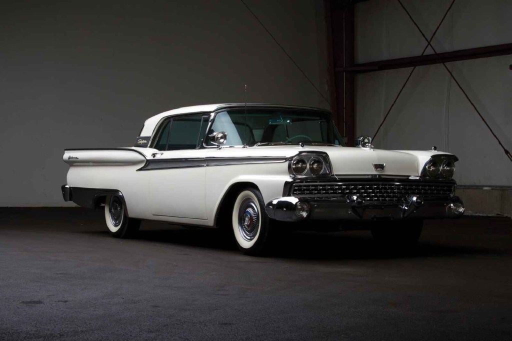 A white 1959 Ford Galaxie is shown parked in right front angle view, the same car used in the Manson family murders.