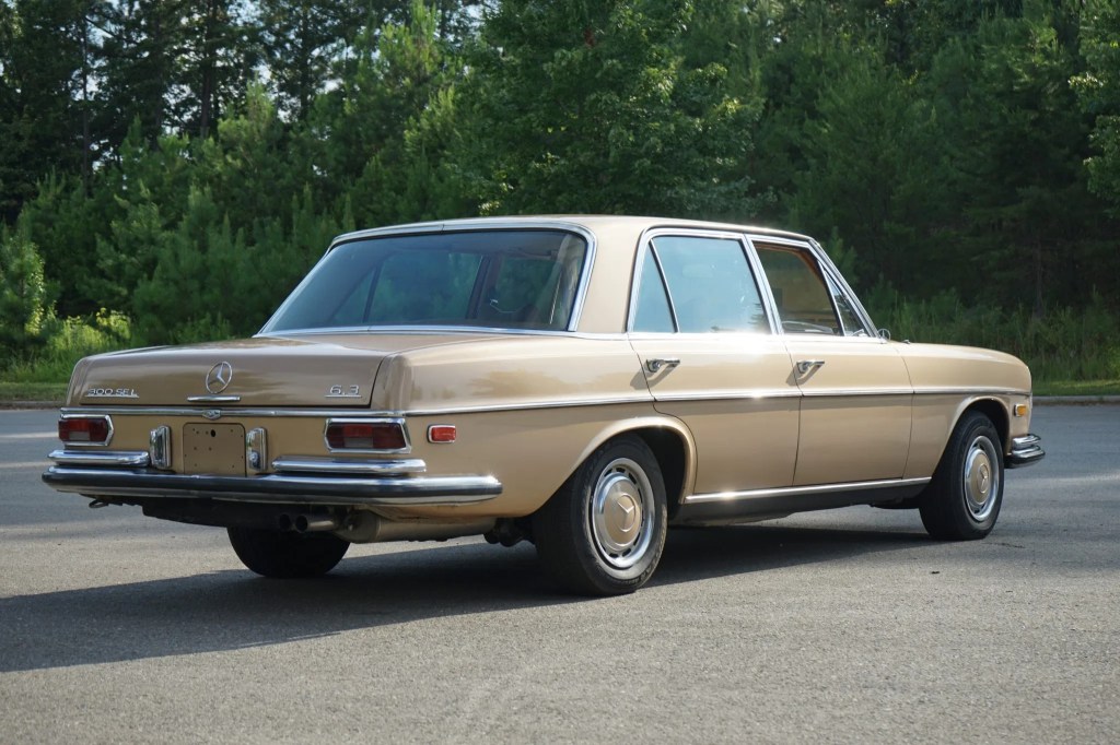 The rear 3/4 view of a tan 1969 Mercedes 300SEL 6.3