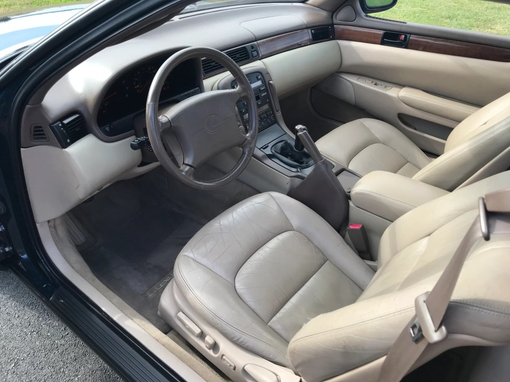 The tan leather interior of a manual-equipped 1996 Lexus SC300