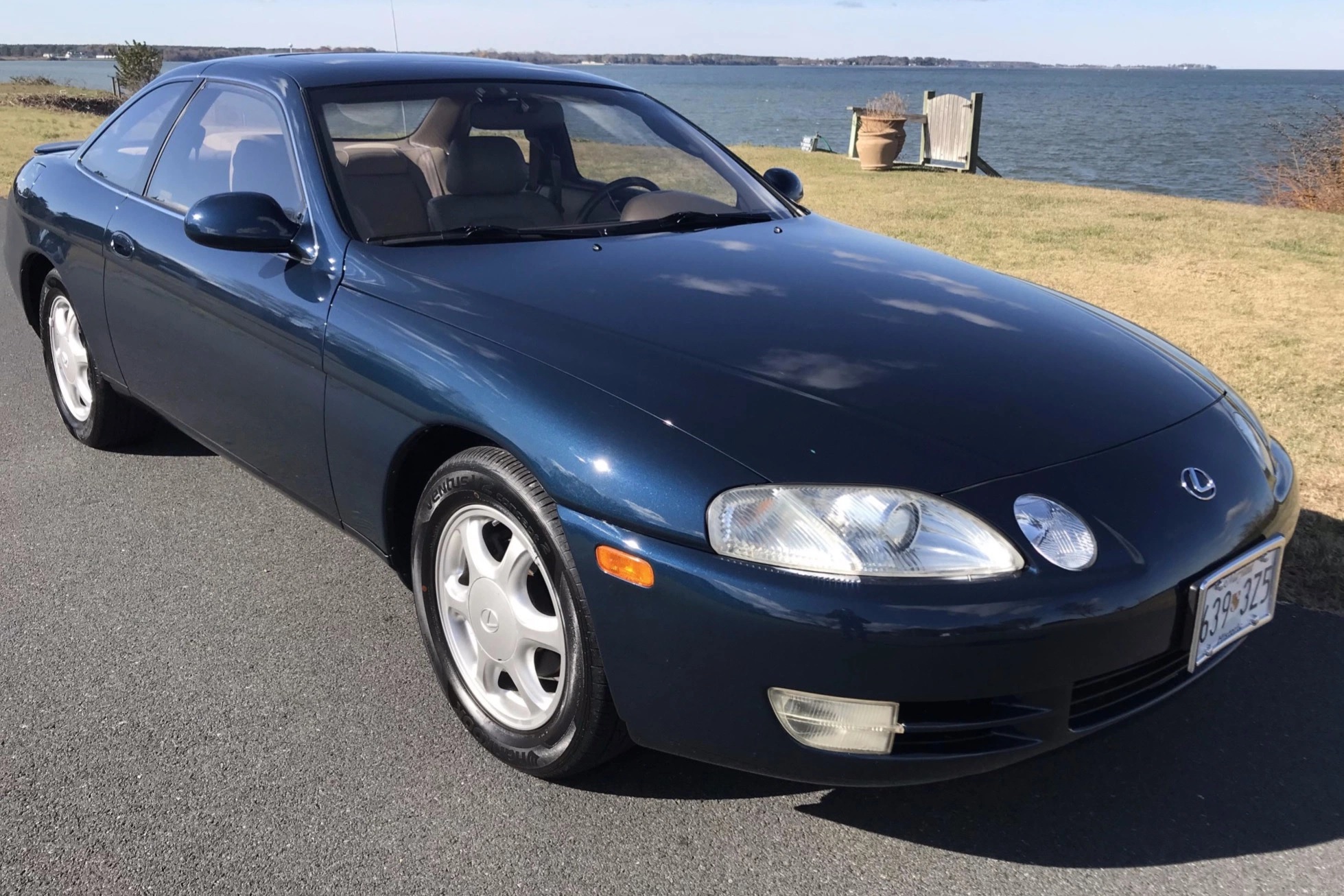 A blue Lexus SC300 coupe at the waterfront