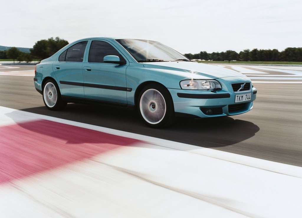 A light-blue 2003 Volvo S60R taking a corner on a racetrack