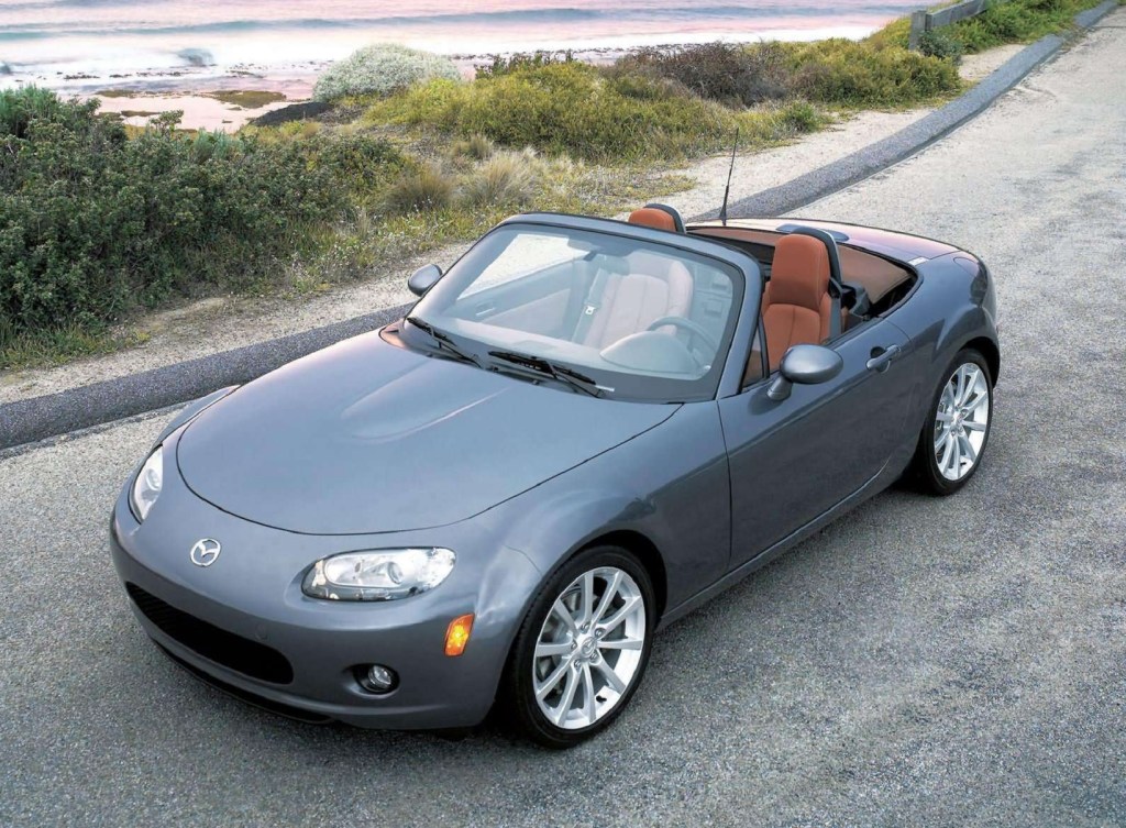 A gray 2006 NC Mazda MX-5 Miata with its roof down