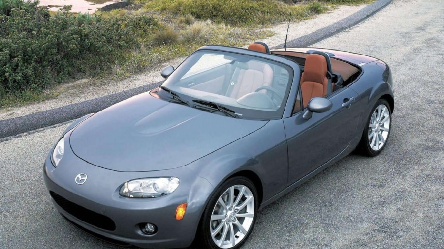 A gray 2006 NC Mazda MX-5 Miata with its roof down