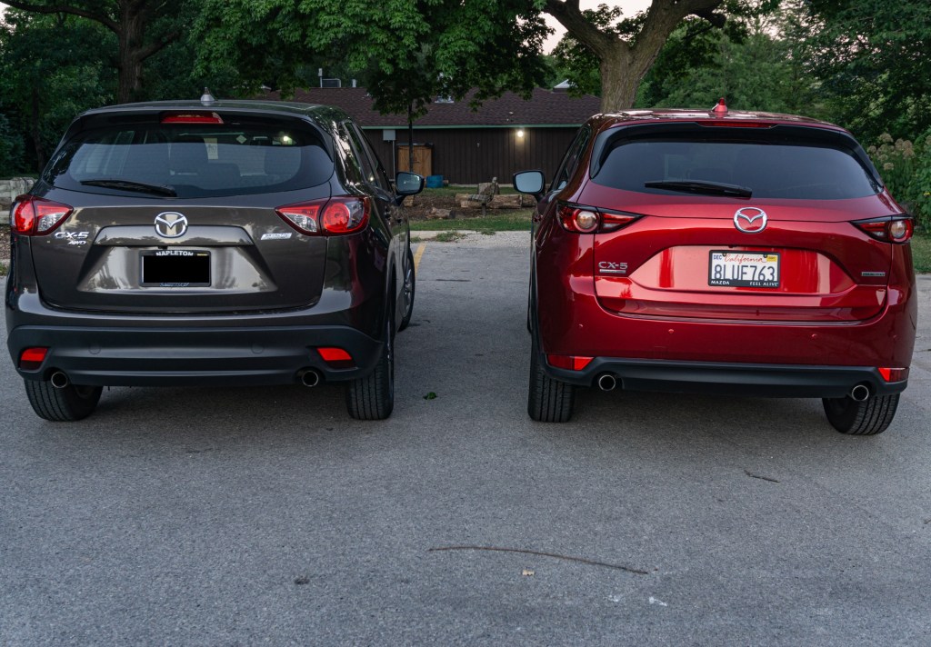 The rear views of a gray 2016 Mazda CX-5 Sport next to a red 2020 Mazda CX-5 Signature