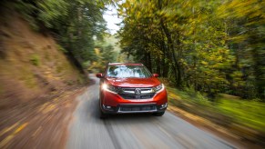 A red 2018 Honda CR-V driving down the countryside.
