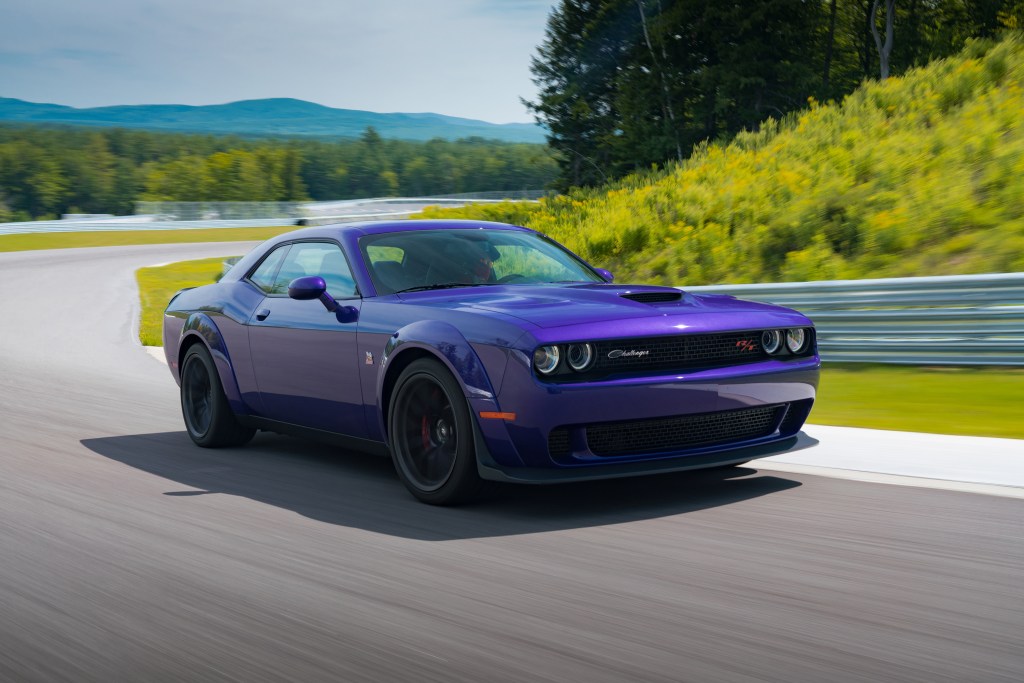 A purple 2019 Dodge Challenger R/T Scat Pack Widebody goes around a racetrack corner