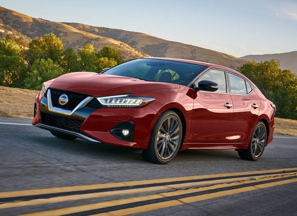 A red 2019 Nissan Maxima on a road in the rolling fields