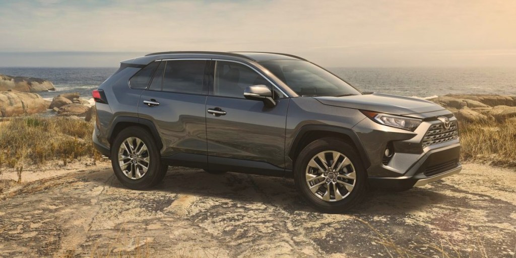 A gray 2019 Toyota RAV4 small SUV is parked off-road.