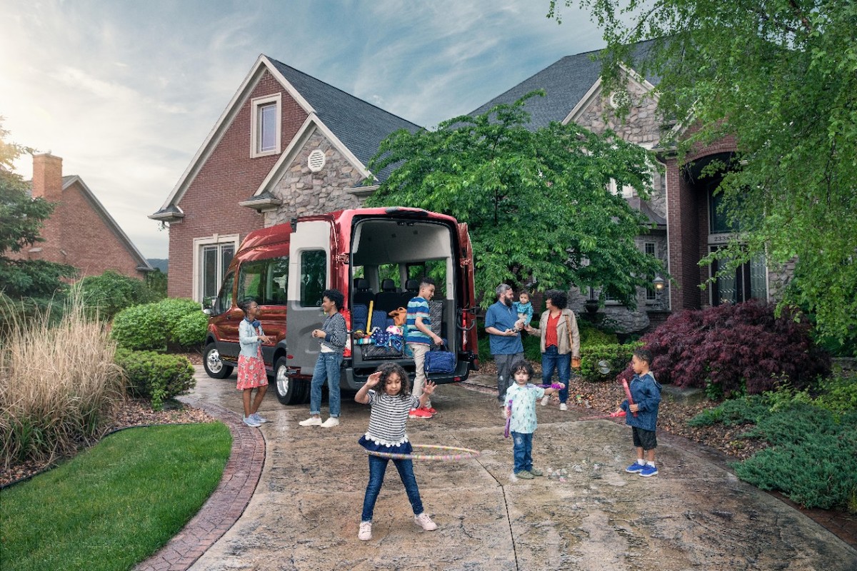 2020 Ford Transit outside of a home with kids playing