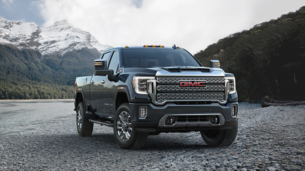 a gray GMC Sierra Denali pickup truck parked in a gravel yard