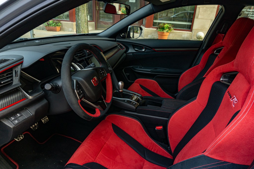 The front part of the 2020 Honda Civic Type R's interior, showing the red bolstered sport seats