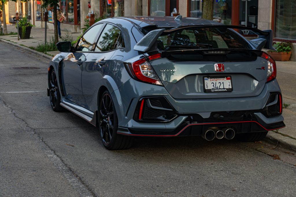 The rear view of a gray 2020 Honda Civic Type R on a city street