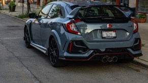 The rear view of a gray 2020 Honda Civic Type R on a city street