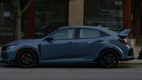 The side view of a gray 2020 Honda Civic Type R on a city street