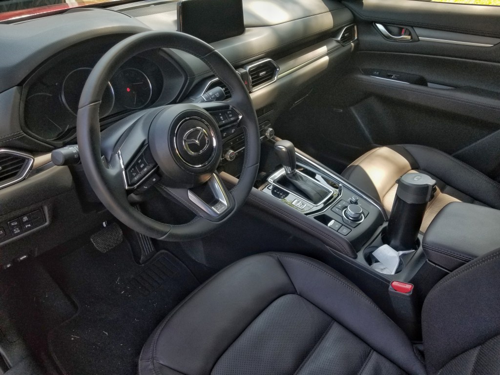 The 2020 Mazda CX-5 Signature AWD's center console with an insulated water bottle in the cupholder