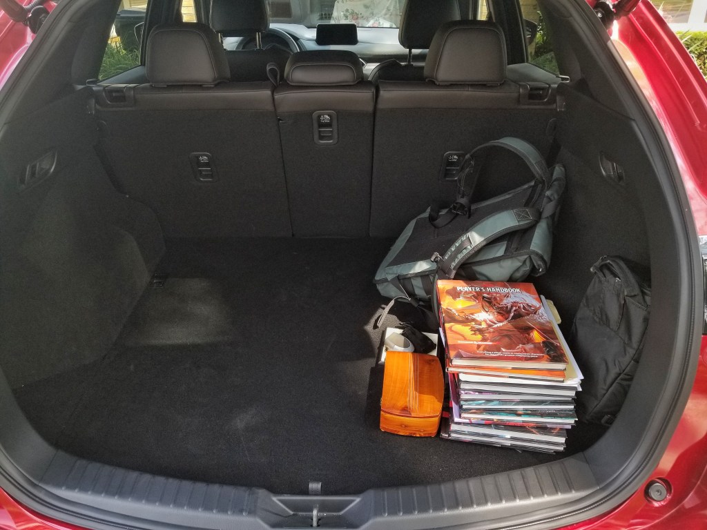 The 2020 Mazda CX-5 Signature AWD's rear cargo area, with a backpack and D&D books