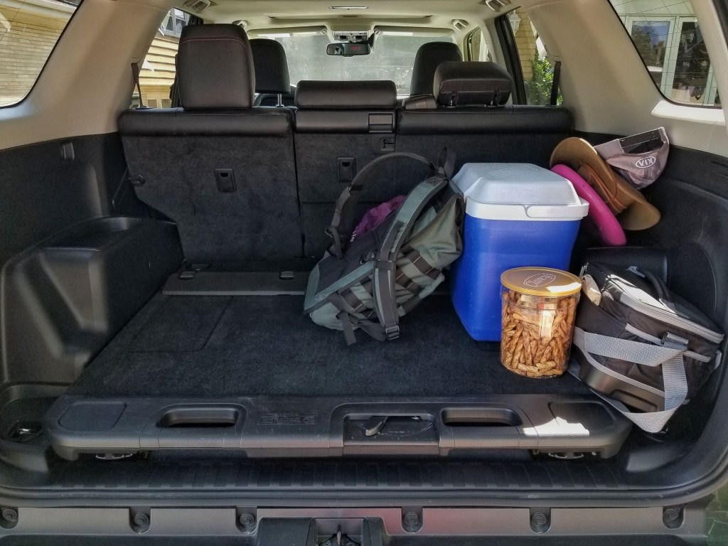 The 2020 Toyota 4Runner TRD Pro's rear cargo area with several coolers, a backpack, and other hiking equipment