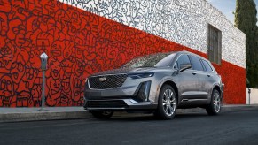 2021 Cadillac XT6 parked in front of a red and white mural painting