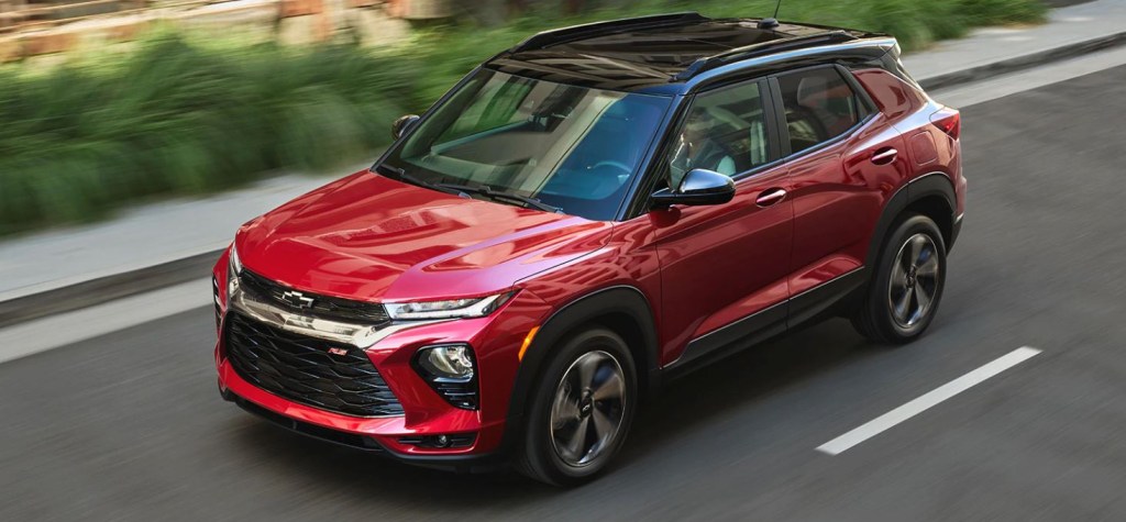 A red 2021 Chevrolet Trailblazer with a block top drives down a road.