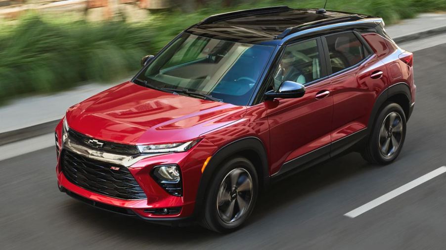 A red 2021 Chevrolet Trailblazer with a block top drives down a road.