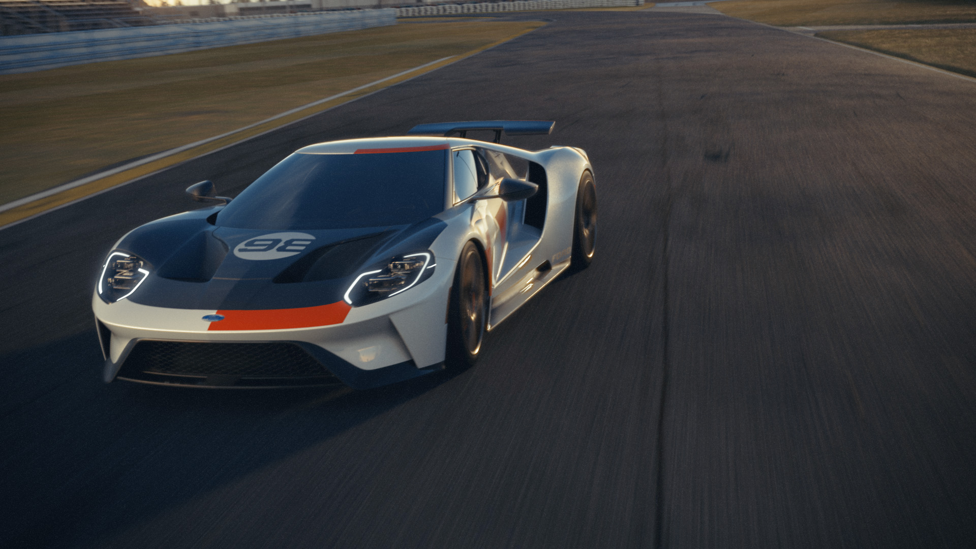 A wide view of a 2021 Ford GT in white taking a straightaway at a racetrack