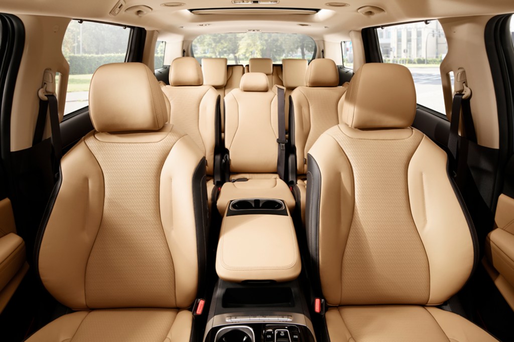 The tan interior of the 2021 Kia Sedona is seen from the front to the back.