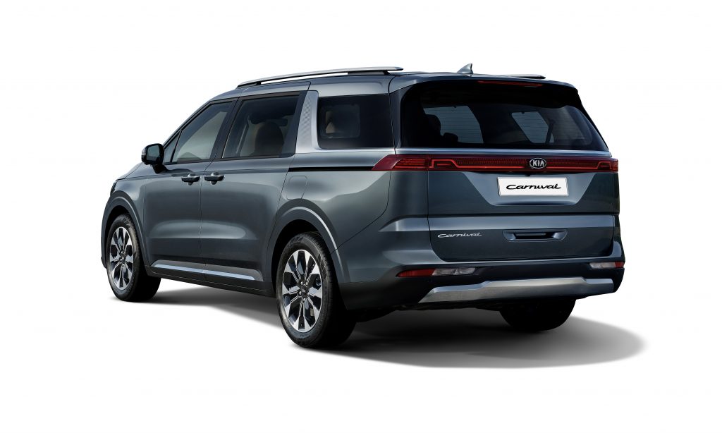 A view of the rear three quarter of the 2021 Kia Sedona in gray.