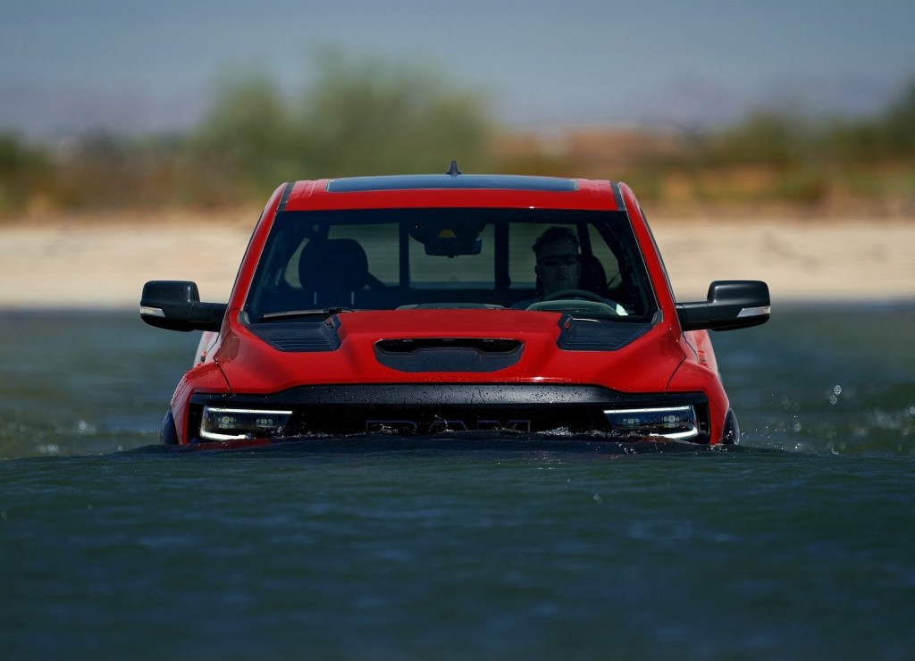 A red 2021 Ram 1500 TRX wading through deep water