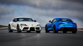 2021 Toyota GR Supra in blue and white parked on a track with overcast skies