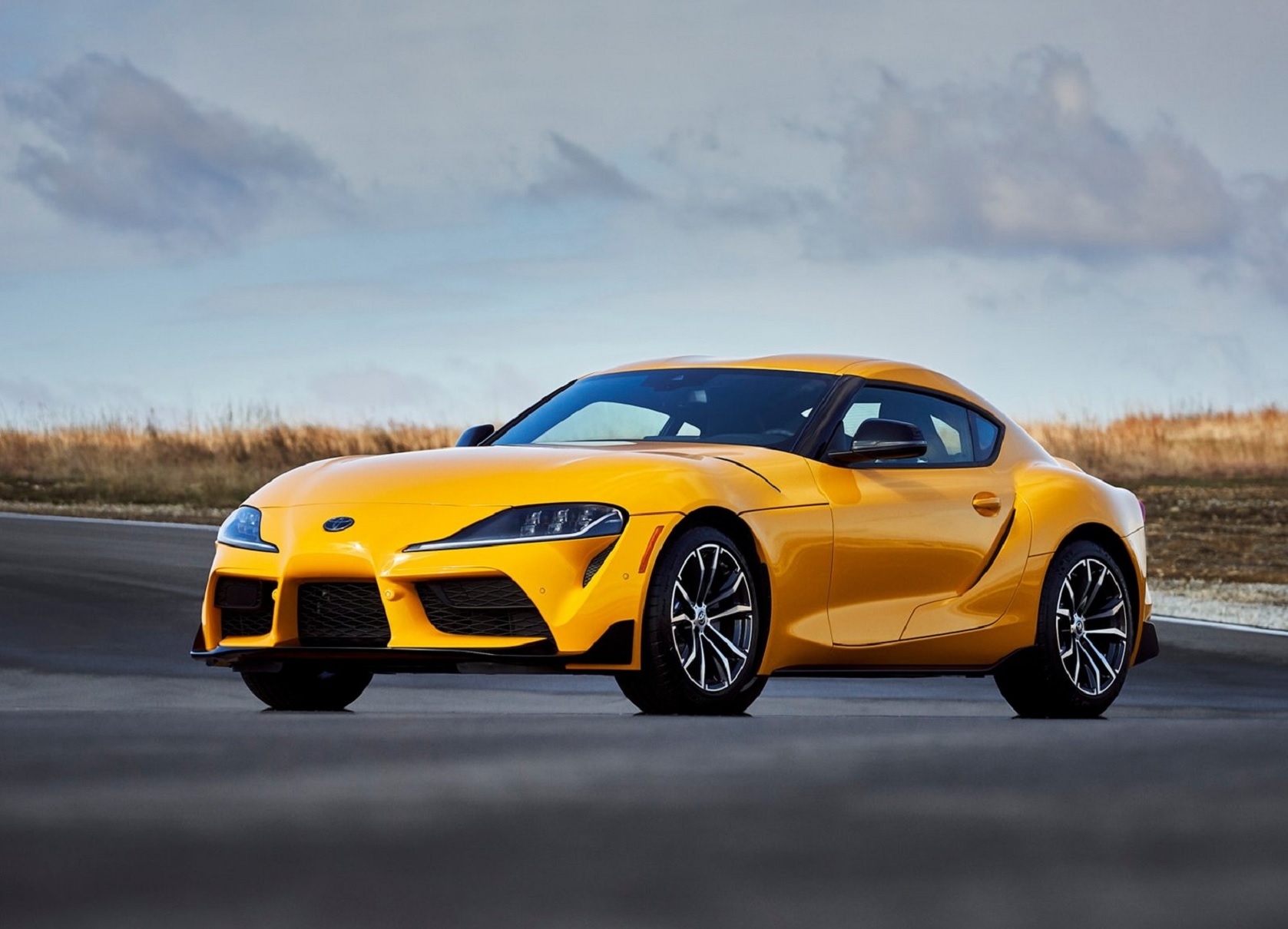 A yellow 2021 Toyota Supra 2.0 parked on a racetrack