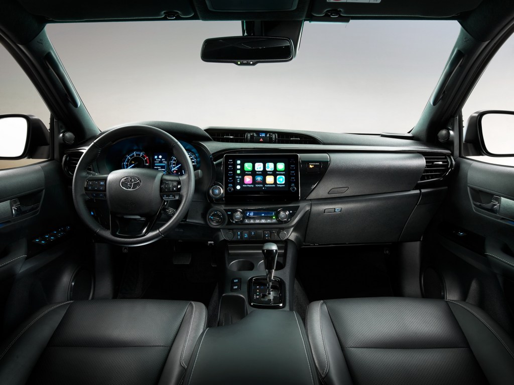 the interior of an Invincible hilux shows the upgraded display and plush leather isn't available in the US
