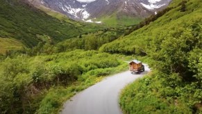Timmy's truck camper driving on an epic Alaskan road