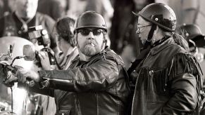 A biker couple wearing black leather motorcycle jackets