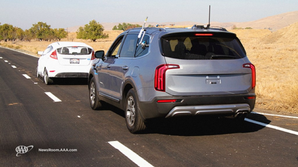 An unmarked silver Kia Telluride follows a simulated disabled vehicle in AAA's 2020 ADAS study