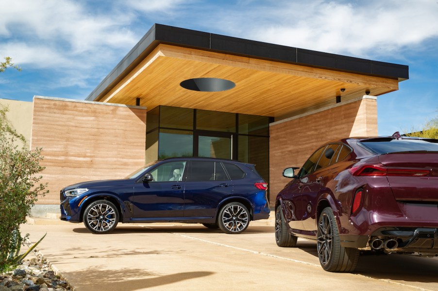 BMW X5 parked under a modern home roof
