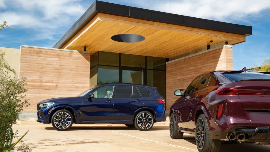 BMW X5 parked under a modern home roof