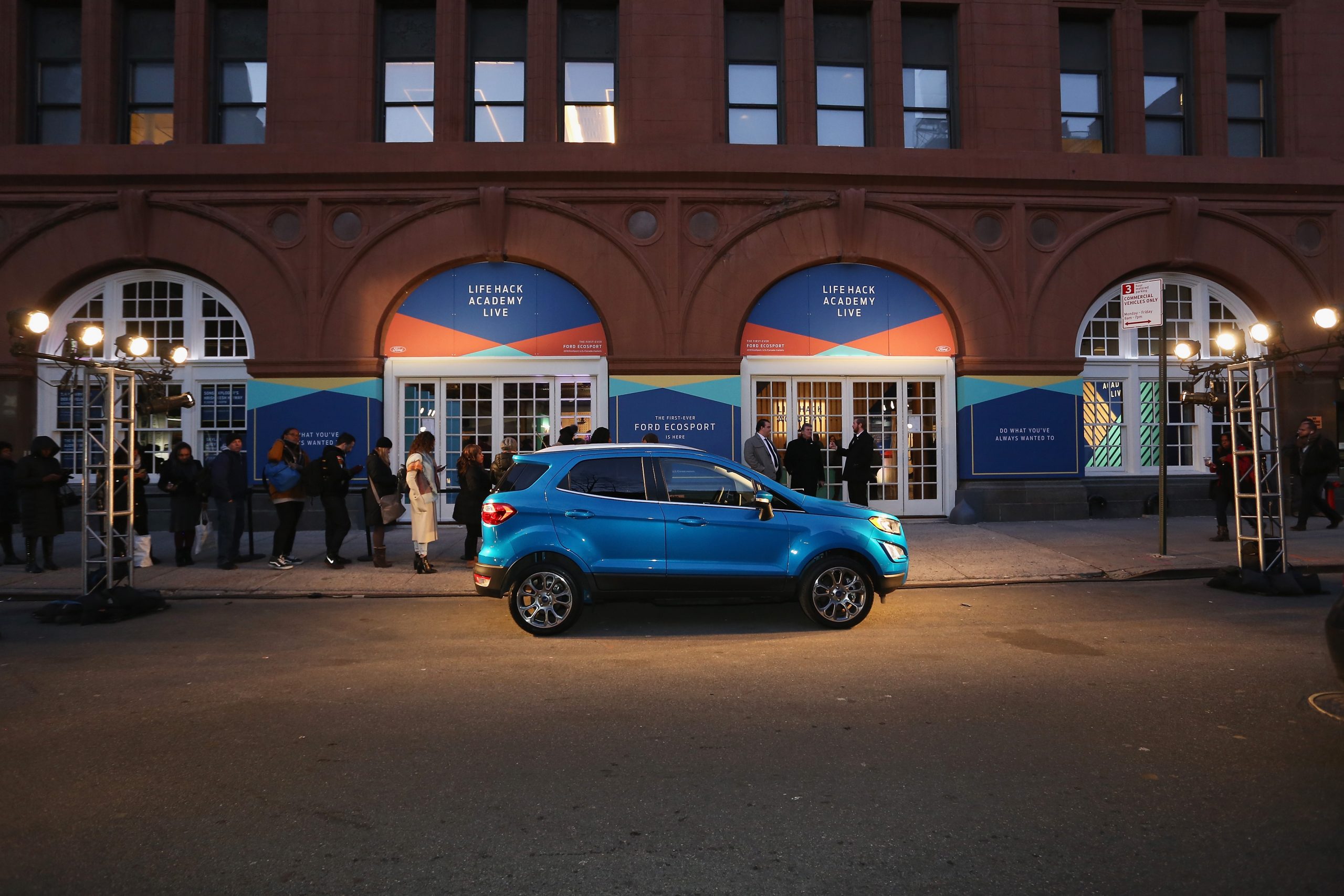 A blue Ford EcoSport parked outside a building