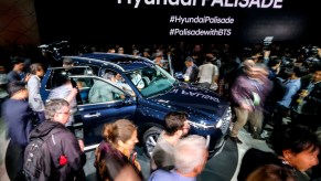 Attendees look at the 2019 Hyundai Palisade SUV during the media preview at the 2018 Los Angeles Auto show