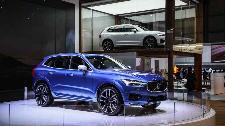 A blue Volvo XC60 on display at an auto show