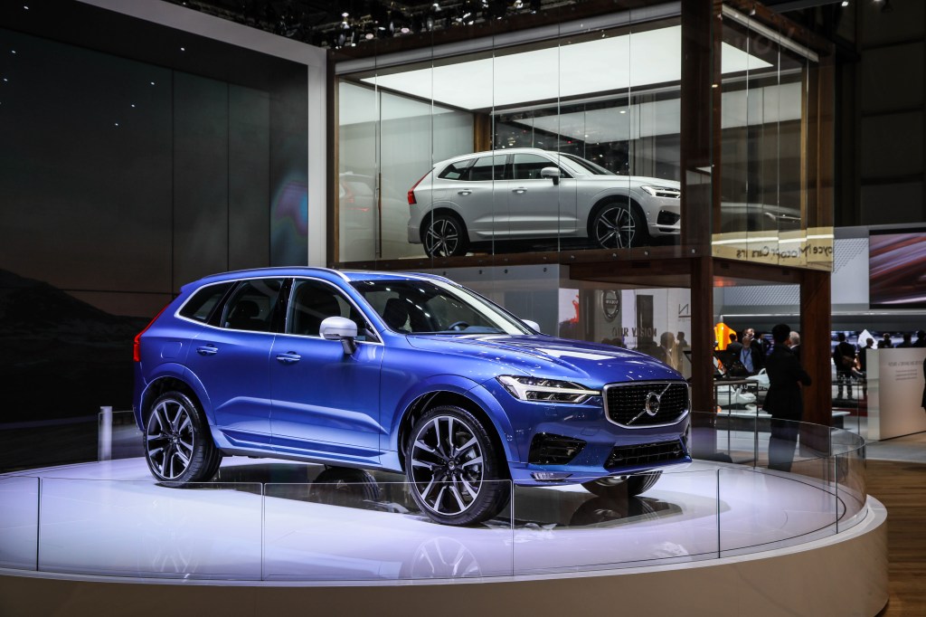 A blue Volvo XC60 on display at an auto show